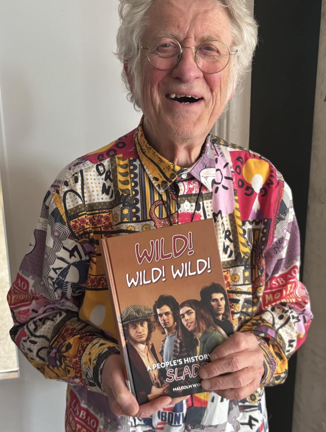 Noddy Holder holding a book