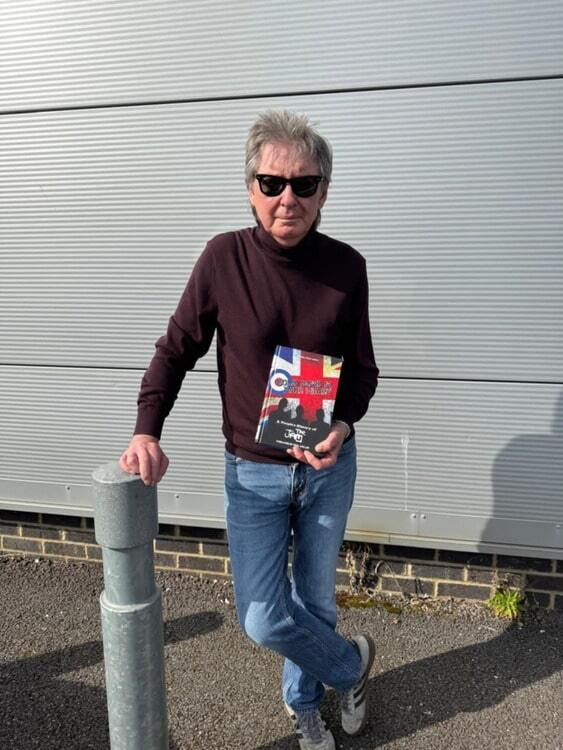 Bruce Foxton holding a book